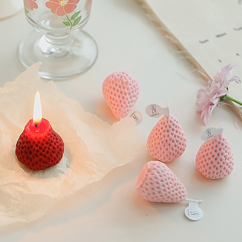 Lit strawberry shape candles