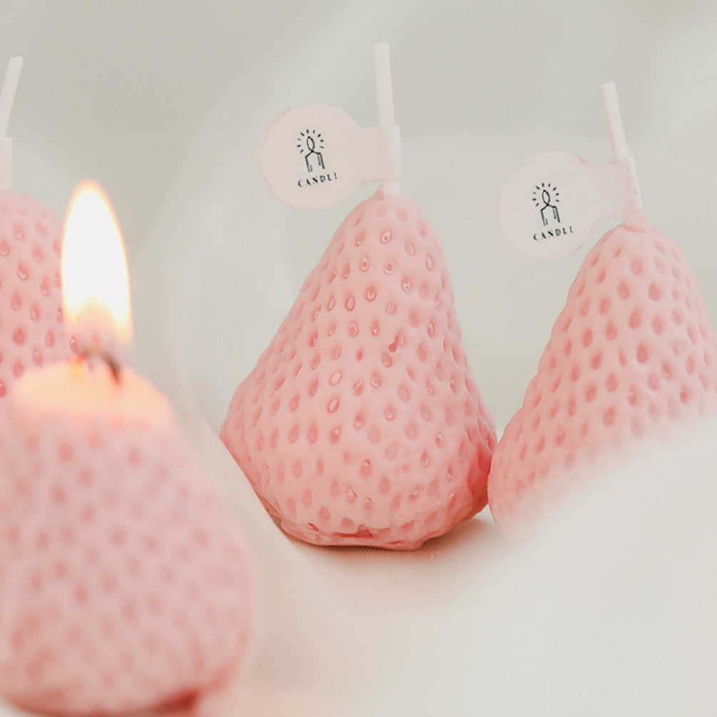 Pink lit strawberry shape candles